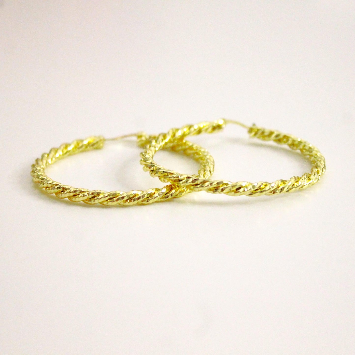 Large twisted hoop earrings